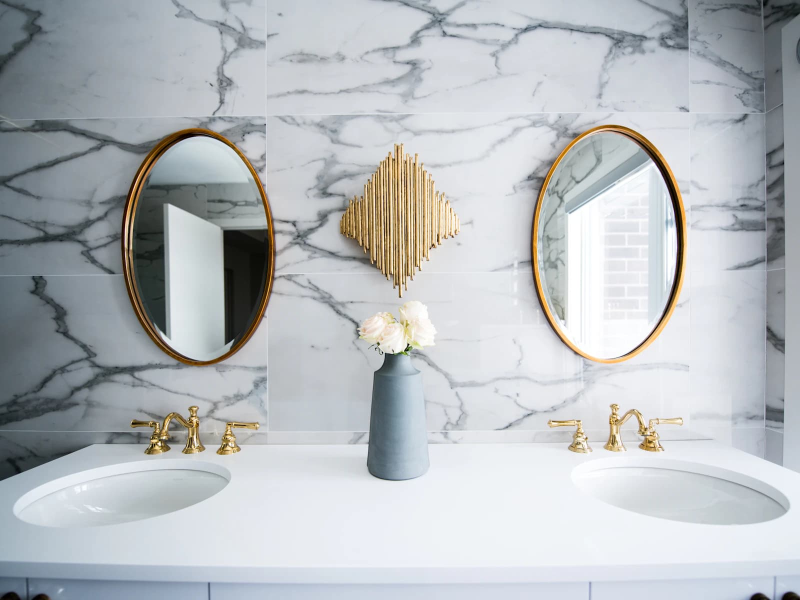 Pair of oval bathroom mirrors over a double vanity