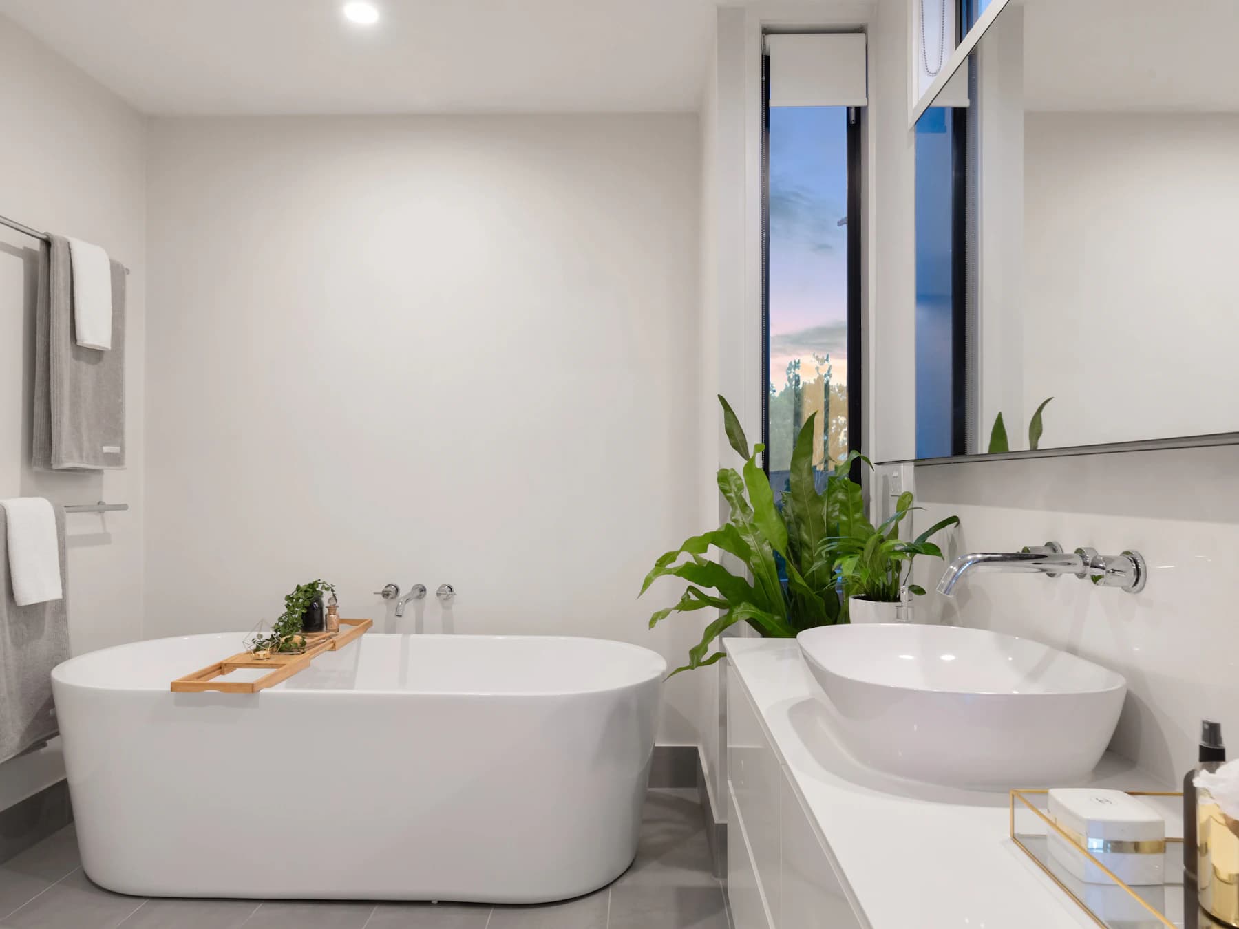 Freestanding bath with a furniture-style vanity and basin