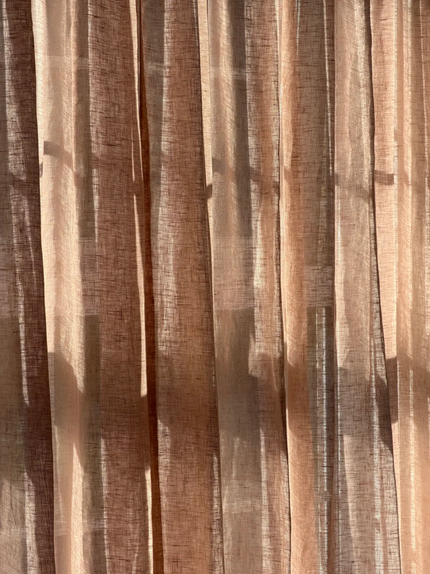 Sheer curtain fabric with sunlight through the weave