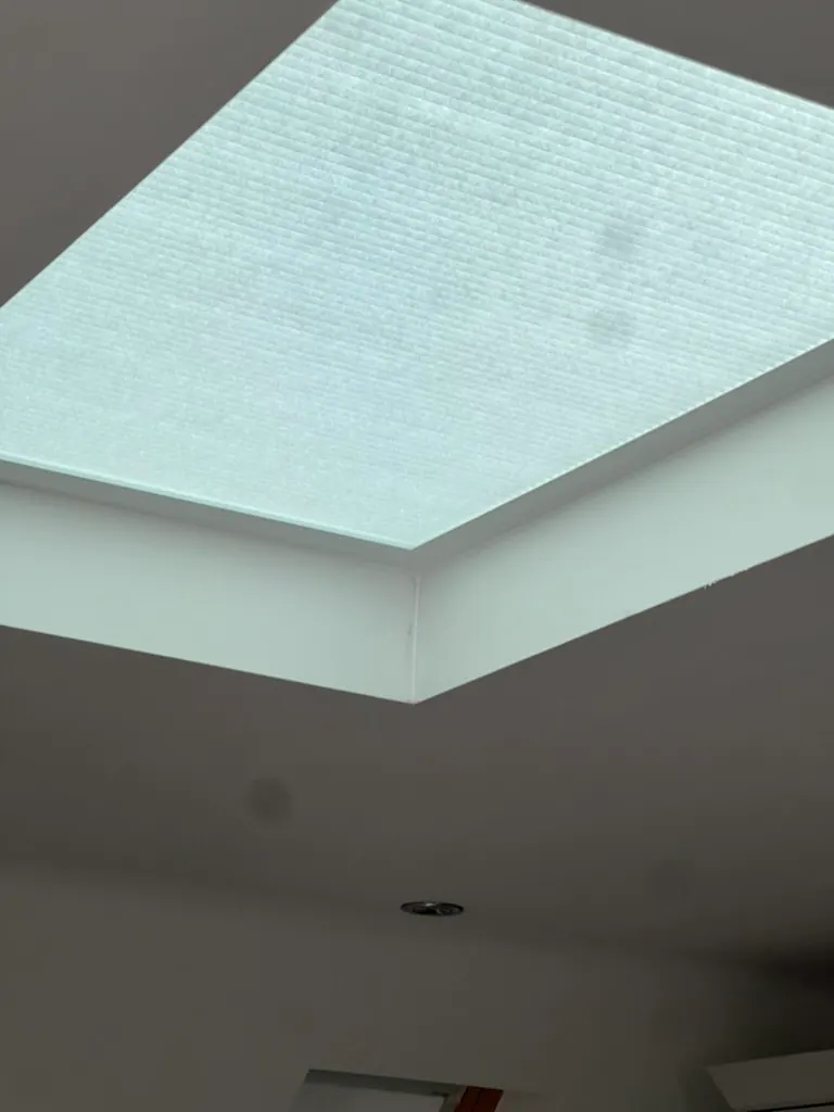 Pleated blind closed across a recessed flat skylight