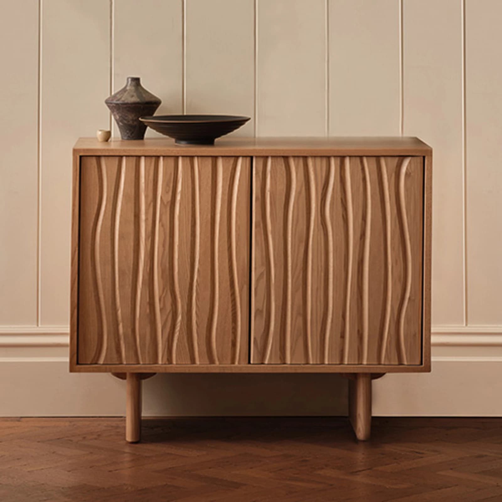 Ercol wooden sideboards and display cabinets arranged in a furniture showroom