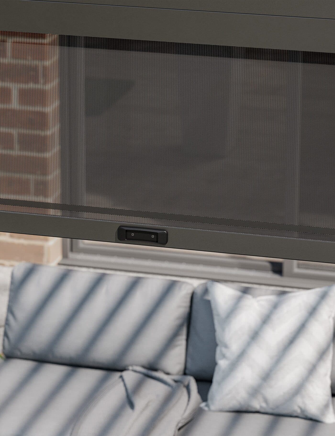 Retractable mesh privacy screen on a louvred pergola