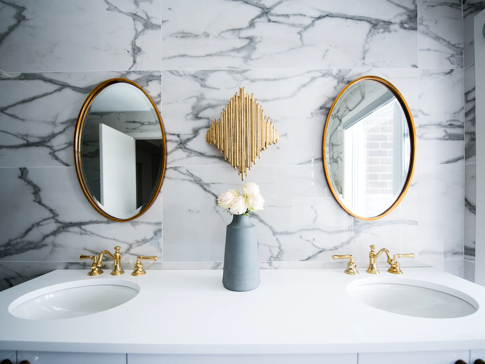 Pair of oval bathroom mirrors over a double vanity