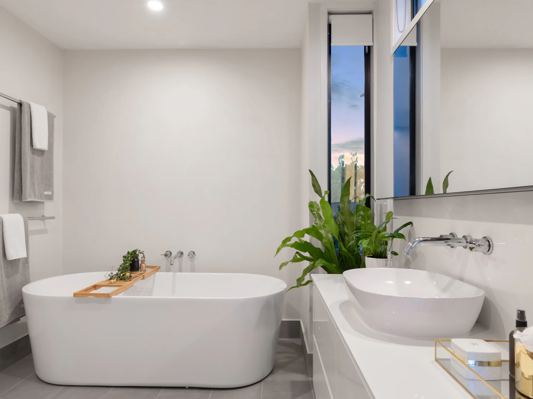 Freestanding bath with a furniture vanity and basin