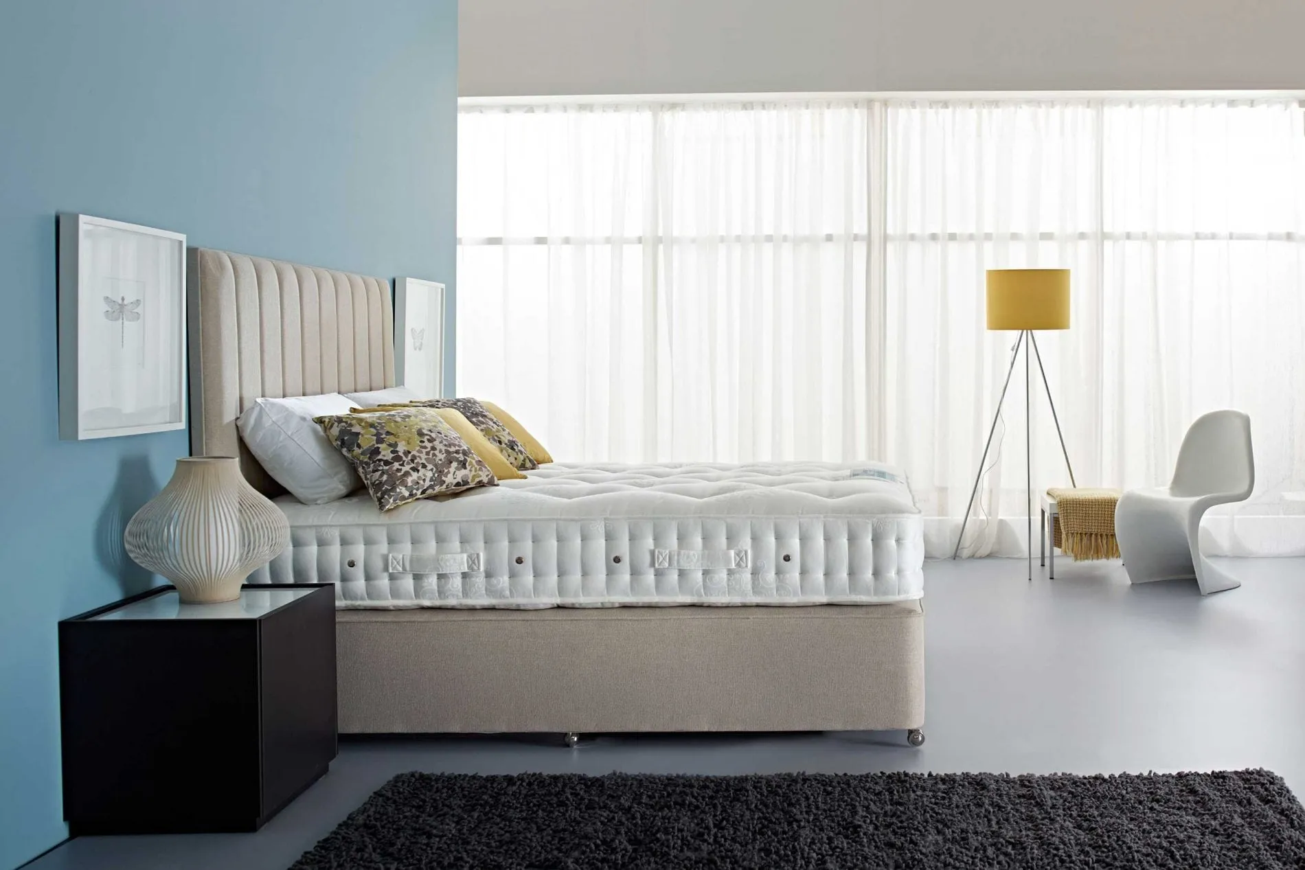 Upholstered bed with layered bedding in a calm bedroom