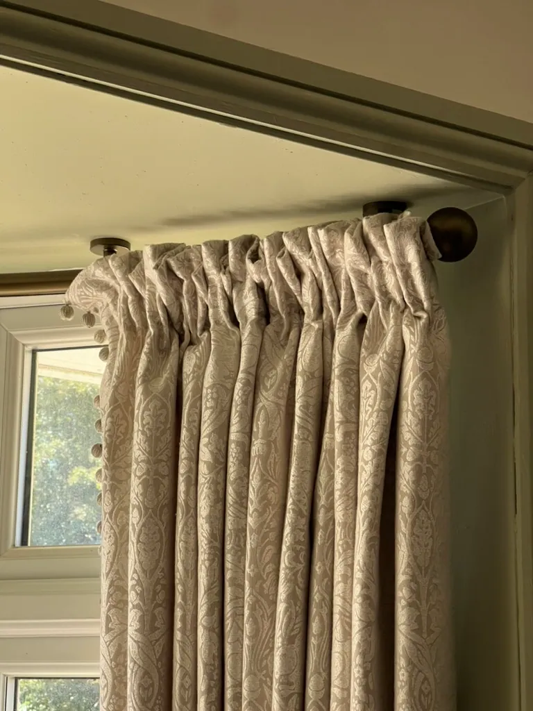 Curtain pole and pinch-pleat heading detail