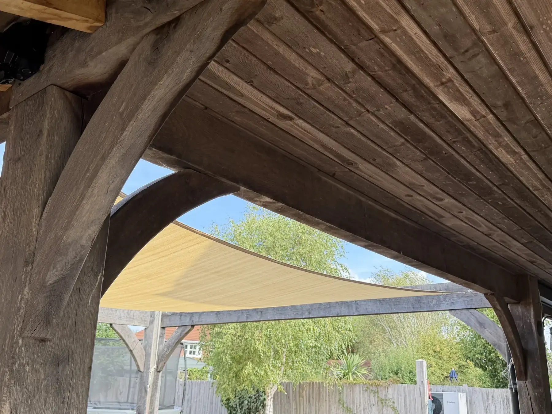 Timber veranda structure before Luxaflex external screen blinds were installed, looking out to garden shade sail