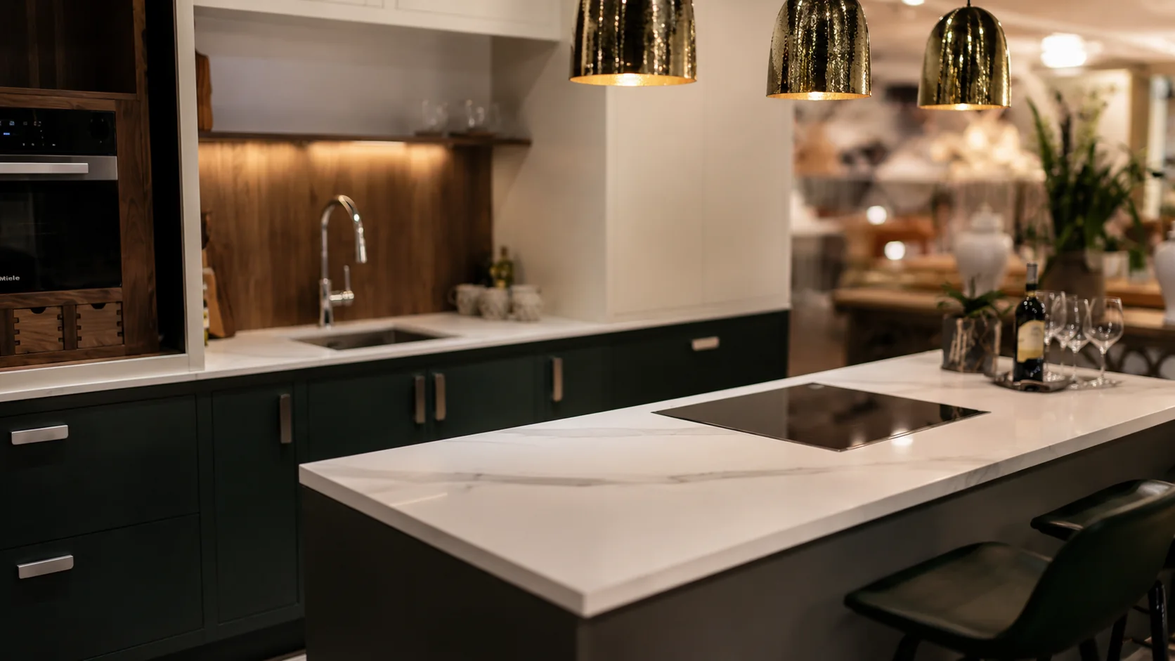 Kitchen interior with marble island and brass pendant lighting