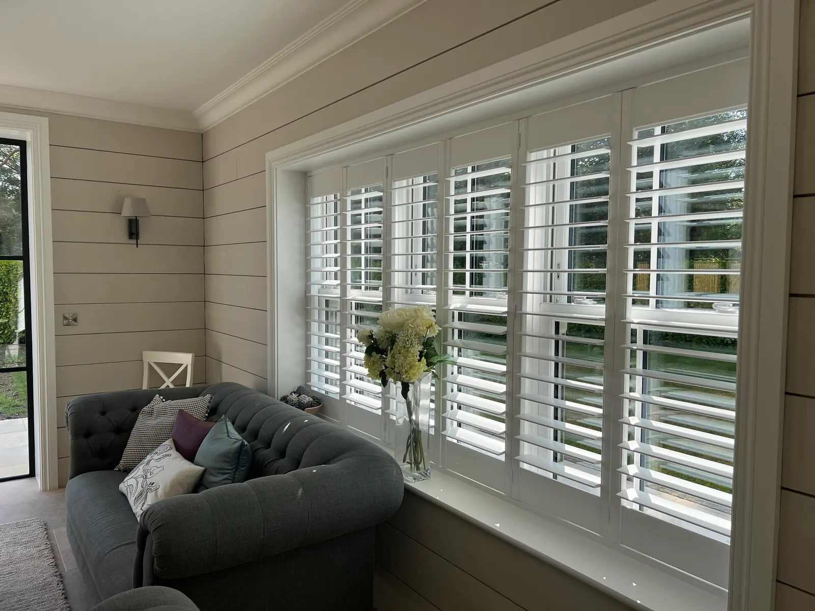 Made-to-measure shutters fitted to a shaped window opening in a New Forest home